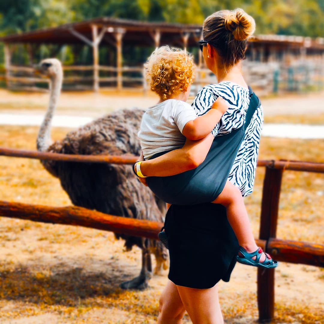 Mother carrying a child by the lake